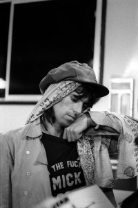 Keith, backstage at Madison Square Garden, Tour of the Americas-1975, wearing infamous 'Who the Fuck is Mick Jagger' T-Shirt. © Ken Regan, 1975